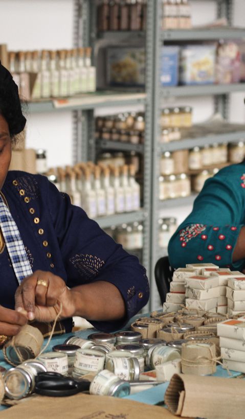 Two women making handcraft products